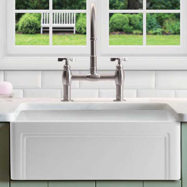 A fireclay or ceramic apron-front farmhouse sink using a gooseneck faucet functions in almost any vintage-style kitchen, but it is more at home in older houses and farmhouses instead of in midcentury ranches.